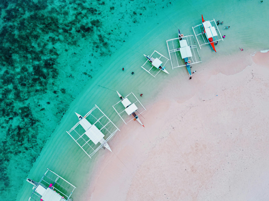 Boats lined up along the shore in the Philippines.