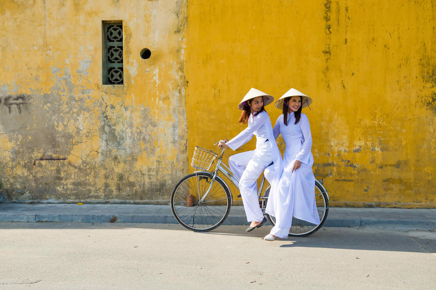 Two Vietnamese women on a bicycle.