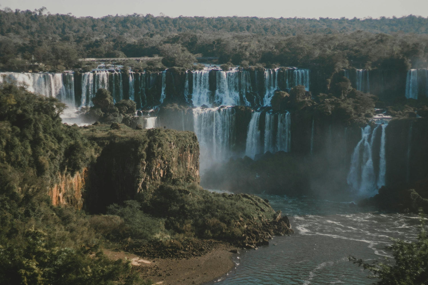Scenic view of a Iguazu falls surrounded by lush greenery