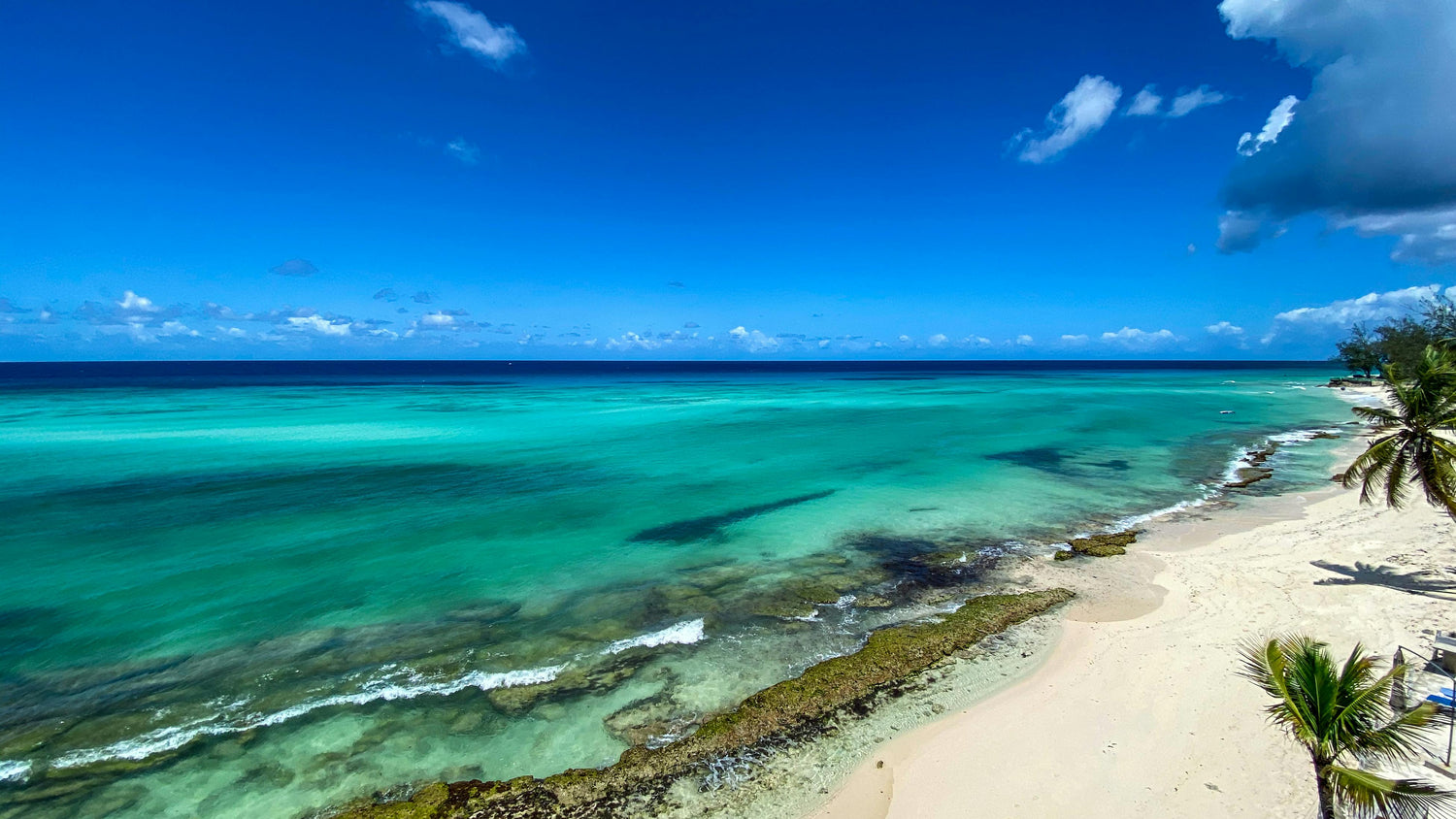 Beach in Barbados with clear turquoise water and blue sky