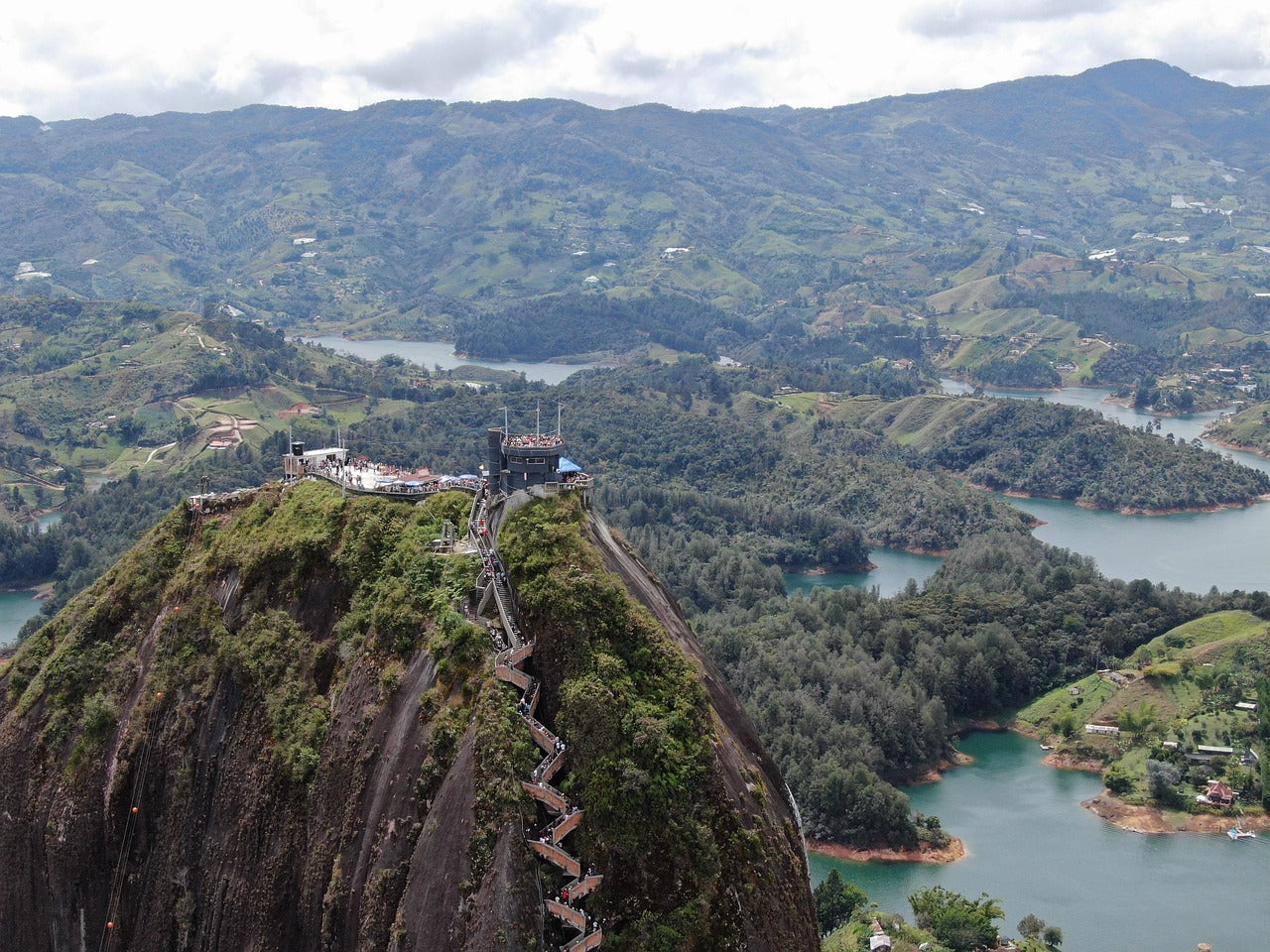 Stairway leading to a lookout point on a mountain with a scenic view of lakes and valleys.