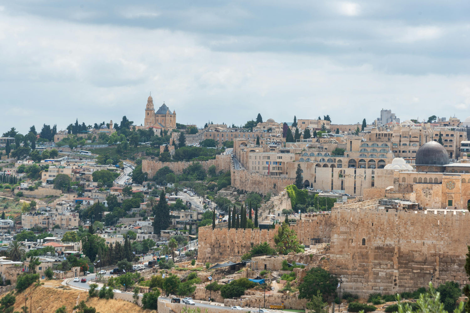 Cityscape in Israel with historical buildings and a cloudy sky