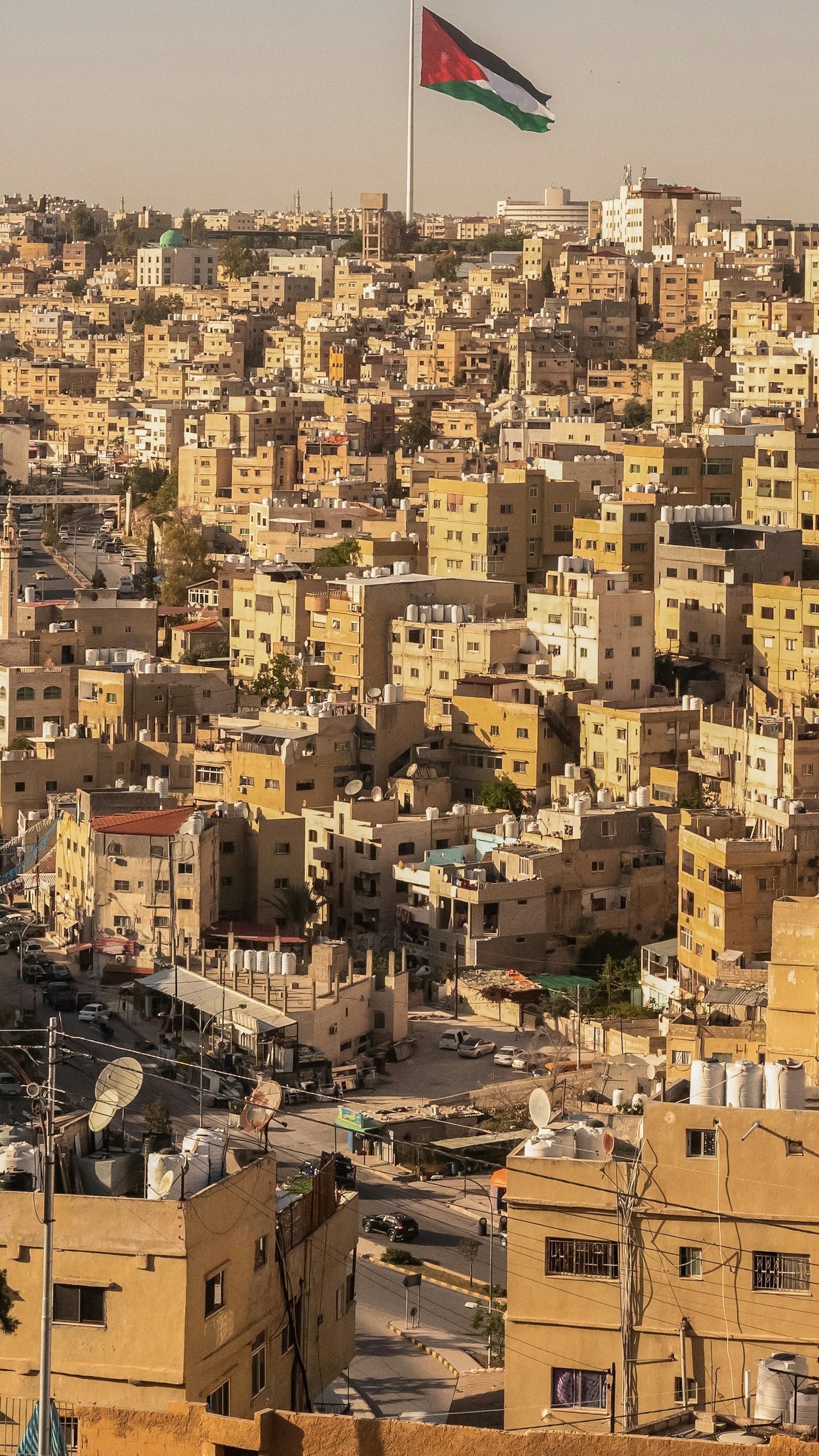 Cityscape of Jordan with buildings and a flag in the background