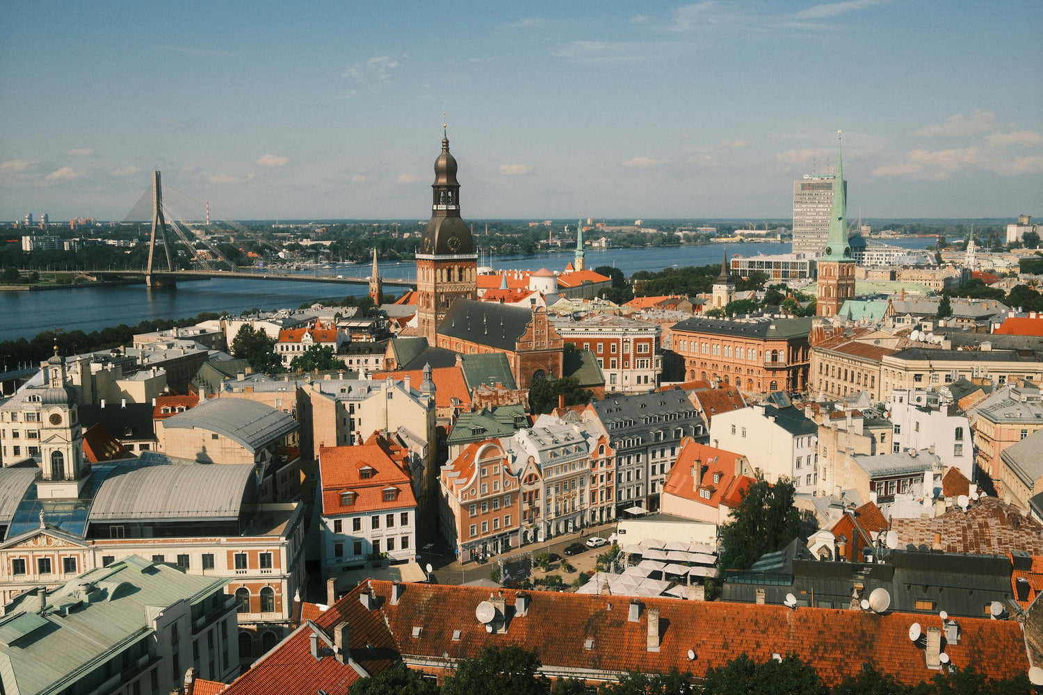 Cityscape in Latvia with historic buildings and a river in the background