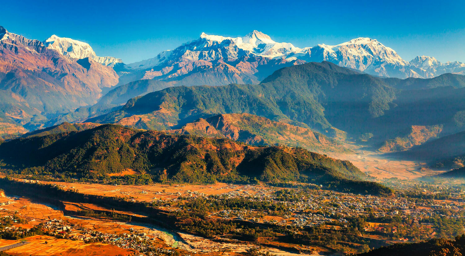 Scenic view of mountains in Nepal with snow-capped peaks and a valley below.