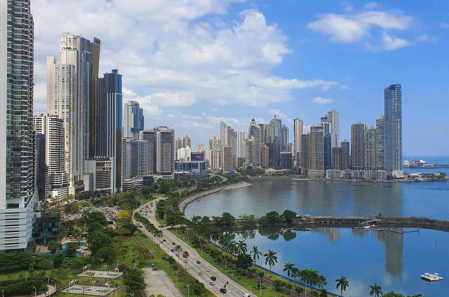 City skyline of Panama with modern buildings and a waterfront area on a clear day.