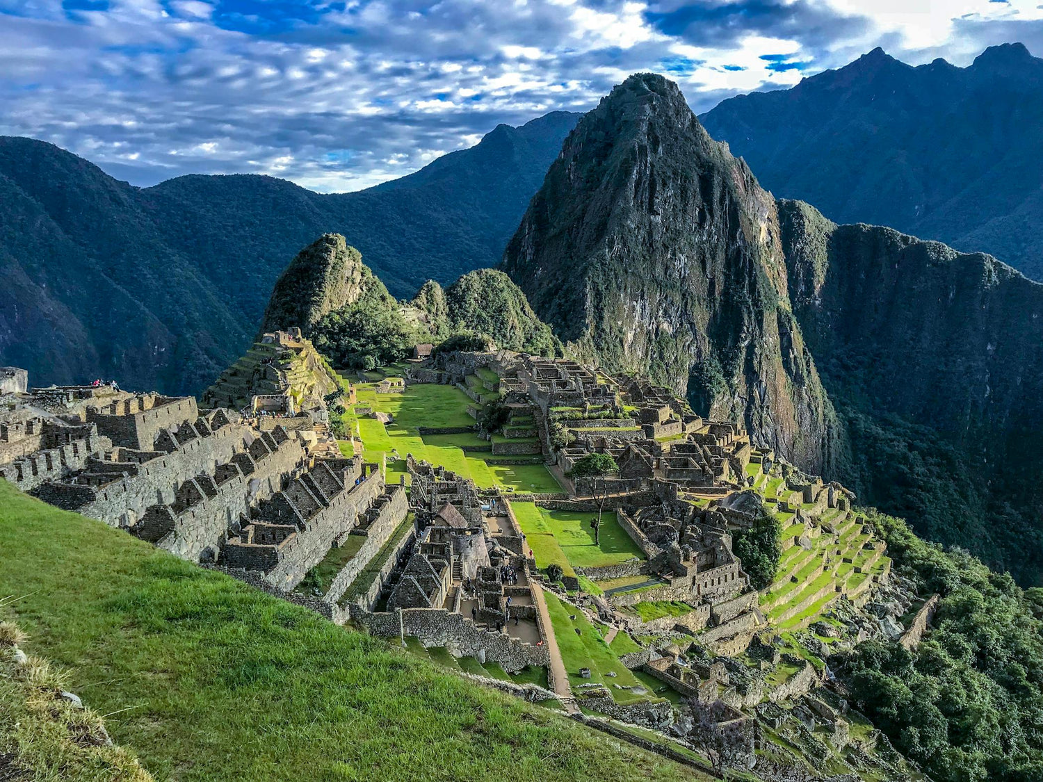 Machu Picchu with stone ruins and greenery against a mountainous landscape