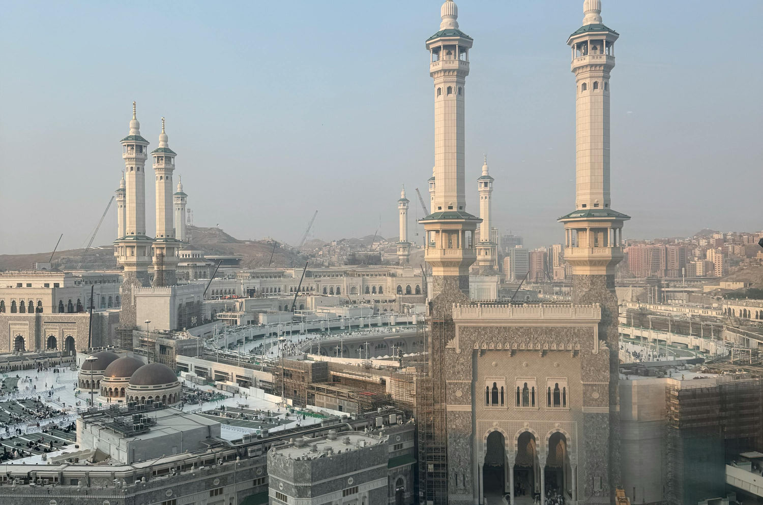 Large mosque with multiple minarets under a clear sky